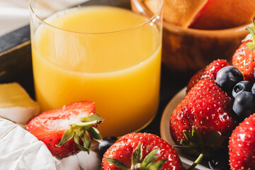 close up view of french breakfast with orange juice and berries