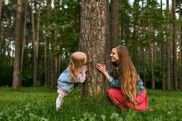 mom and daughter play and have fun in the park