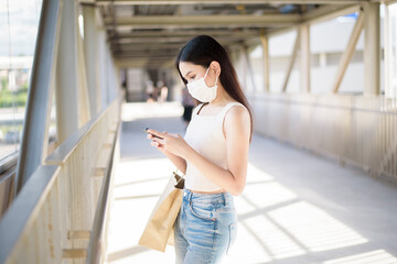 Young woman with face mask is standing outdoor City