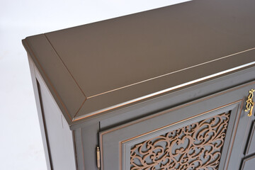 Vintage wooden chest of drawers anthracite color in classic style with carved elements on curved legs on a white background