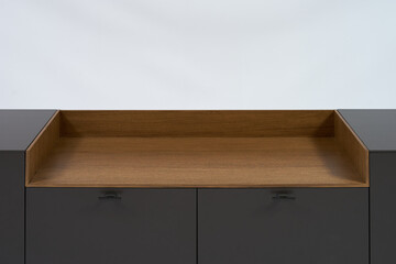 Modern minimalist TV stand graphite color with a decorative insert made of natural wood on a white background