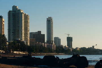 An evening by the beach: Tall Buildings standing by the seashore in Mumbai City