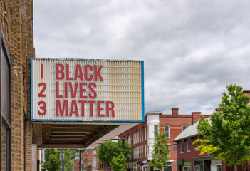 Fototapeta premium Mockup of movie cinema billboard with message of Black Lives Matter on the marquee in downtown street