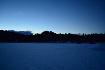 beautiful frozen river and mountain landscape in the high north winter