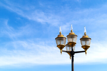 vintage electric lamps post in public park.