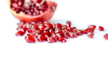 Ripe and juicy pomegranate cut on a white background