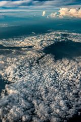 Beautiful aerial cloudy sky with volcano above Java Island, Indonesia view. Taken from airplane window by digital camera