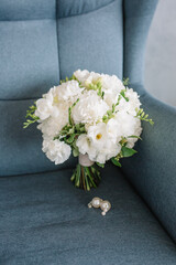 Beautiful girl’s bouquet in the hands of carnations and other flowers