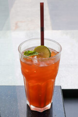 Fresh ice tea in a glass on table.