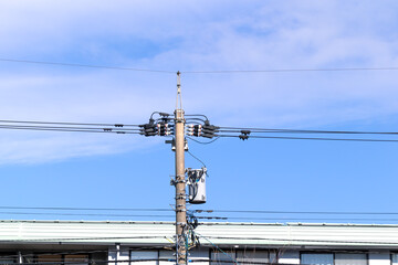 Steel electric tower and cables with blue sky background in JAPAN.
