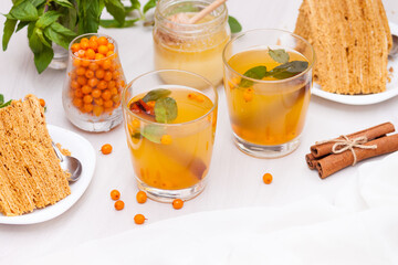 Tea with sea buckthorn, mint, honey, cinnamon, honey layered cake medovik.