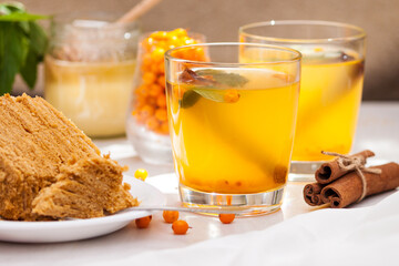 Tea with sea buckthorn, mint, honey, cinnamon, honey layered cake medovik.