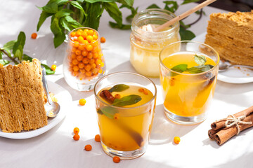 Tea with sea buckthorn, mint, honey, cinnamon, honey layered cake medovik.