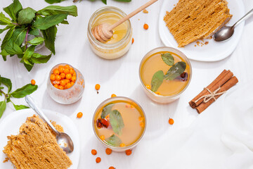 Tea with sea buckthorn, mint, honey, cinnamon, honey layered cake medovik.