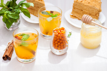 Tea with sea buckthorn, mint, honey, cinnamon, honey layered cake medovik.