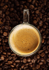 Cappuccino cup on coffee beans