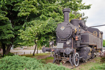 Novi Sad, Serbia - May 31. 2020: An old locomotive is on display in front of the station in the city of Novi Sad 