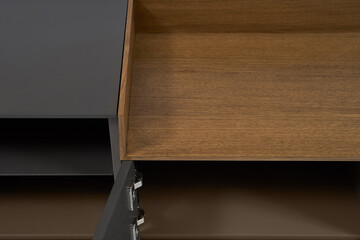 Modern minimalist TV stand graphite color with a decorative insert made of natural wood on a white...