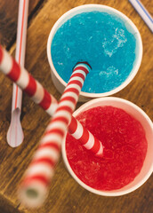 Tasty and appetising, colourful flavoured slush drinks with colourful straws