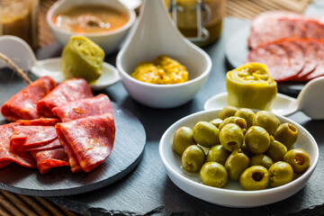 Assortment of tapas and antipasti on black background
