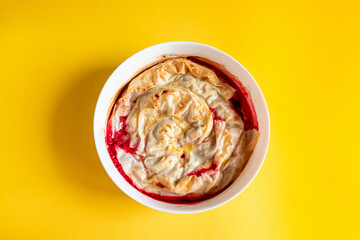 Homemade summer cherry berry tart pie on yellow background, top view