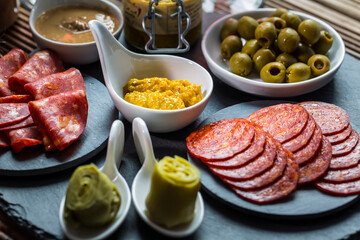 Assortment of tapas and antipasti on black background