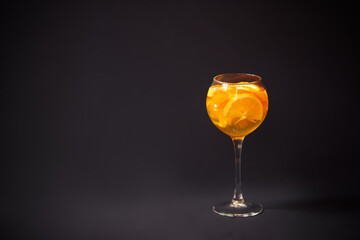 Glass of white wine sangria with orange and lemon. View with copy space.