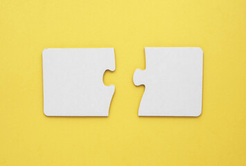 two empty puzzles for text on a yellow background 