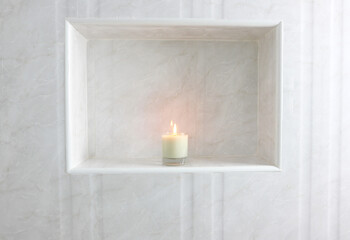 Fototapeta na wymiar The luxury lighting aromatic scent glass candle display in the luxury design white toilet bathroom to creat relax and good scent cozy ambient on holiday