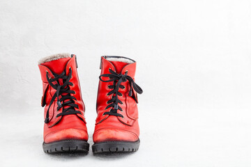 Pair of old leather red discarded boots with laces