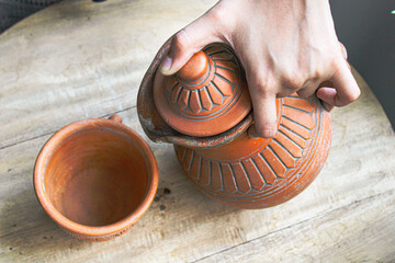 clay jug on wooden table
