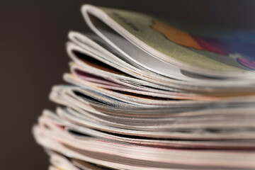 Stack of magazines on black background with narrow depth of field. Black background