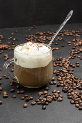 Ice cream and Glass with coffee. Coffee beans scattered on table. Hot summer cool drink.
