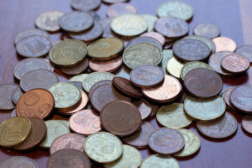 Euro coins in wood background.