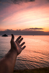 Man hand with sky background.