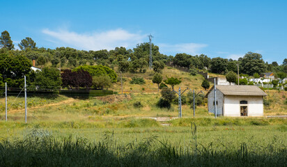 Obraz premium old train station in a country town surrounded by greenery
