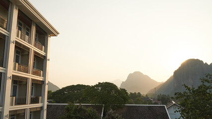 Exterior View of House Roofs and Mountainous During the Sunset in Vang Vieng, Laos. The Landscape of Unseen View of Vang Vieng.