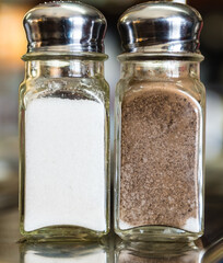 A salt and pepper shakers on a marble table