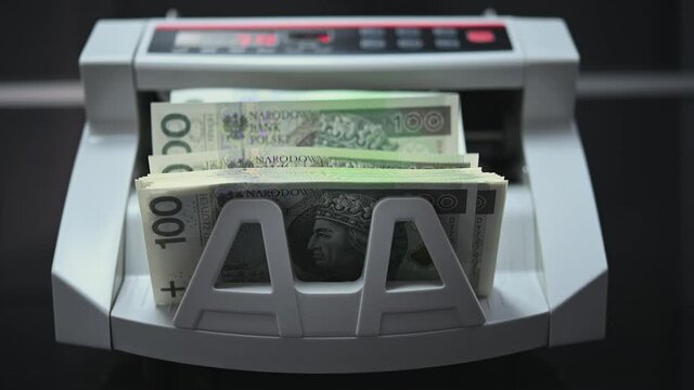 Hand Of Bank Teller Picking Up Stack Of Foreign Banknotes And Putting Cash Into Electronic Bill Counter Machine To Calculate Amount. 