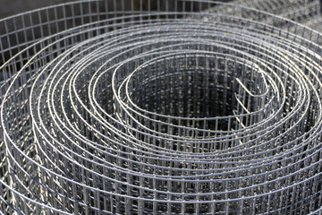 Stainless steel wire mesh. Metal fence, grill, wire screen. Expanded metal, wire canvas. Construction material in store.
