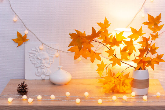 White living room minimalist interior shelf mockup. Autumn decoration room home interior. Cozy light garland yellow maple leaves lamp. Modern empty wall. Copy space selective focus long banner design