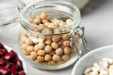 Beans assortment on white stone table, close up.
