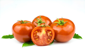 Fresh tomatoes with green leaves isolated on a white background.