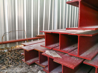 Pile of steel beam paint red color preparing for structure construction.