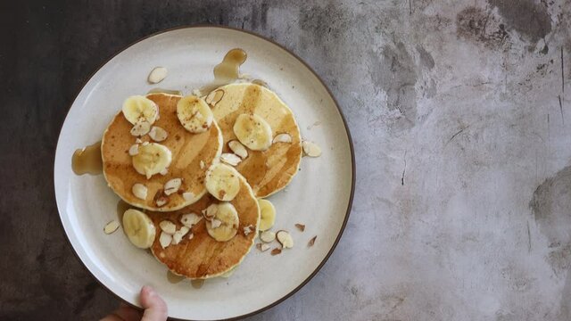 Serving Banana Nut Pancakes with Syrup