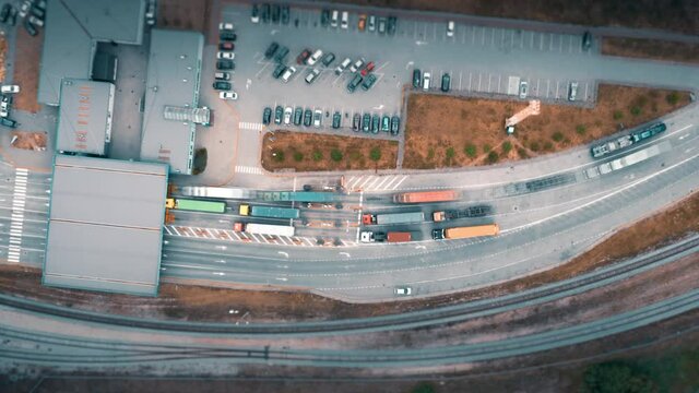 Trucks and lorries delivering cargo containers going through inspection, aerial timelapse