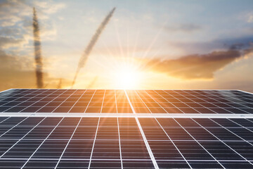 Solar panels or Solar cell in with orange sky and sunset or sunrise. Alternative electricity source and energy concept