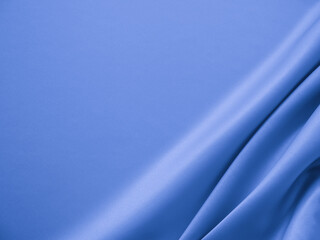 Smooth elegant wavy blue satin silk luxury cloth fabric texture, abstract background design.

