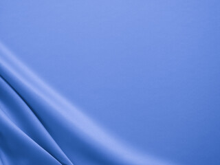 Smooth elegant wavy blue satin silk luxury cloth fabric texture, abstract background design.
