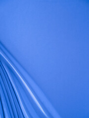 Smooth elegant wavy blue satin silk luxury cloth fabric texture, abstract background design.
